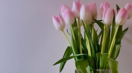 Fresh pink tulips in a vase at KB Nails, Livingston, Scotland, GB, adding elegance to the serene setting.