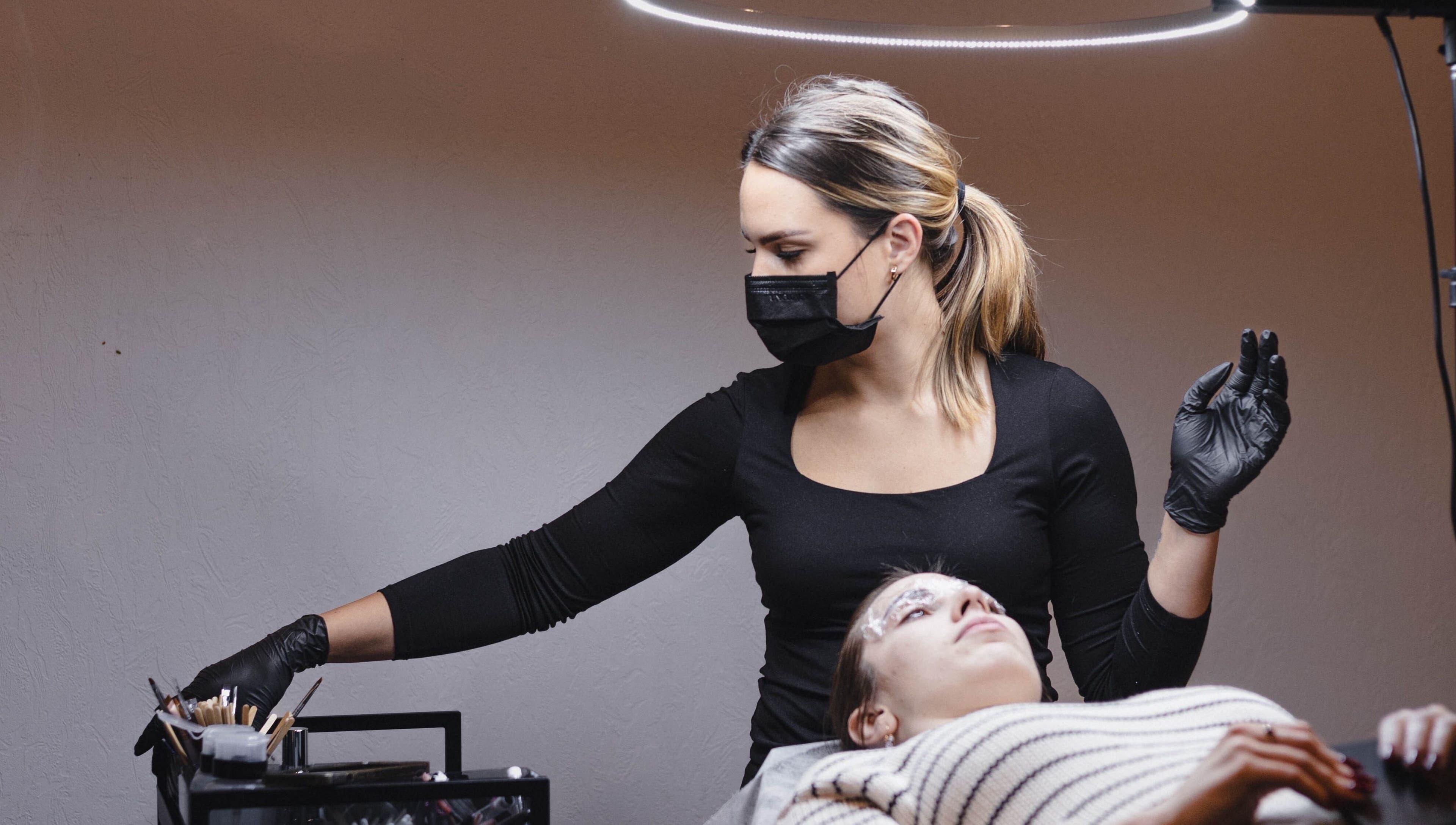 Esthetician performing beauty treatment at Daniella.Esthetics, Rīga, LV. Relaxing ambiance and professional care.