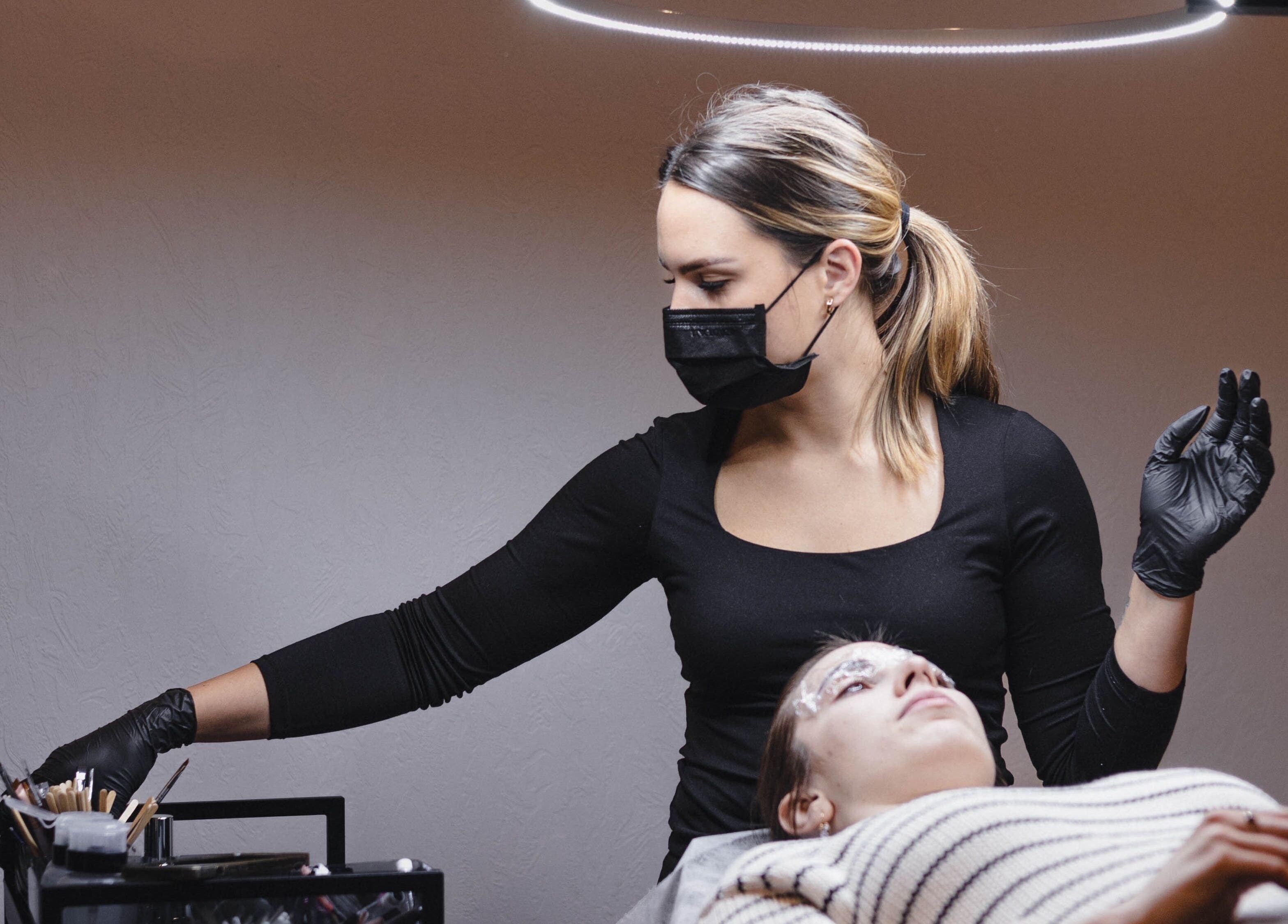 Esthetician performing beauty treatment at Daniella.Esthetics, Rīga, LV. Relaxing ambiance and professional care.