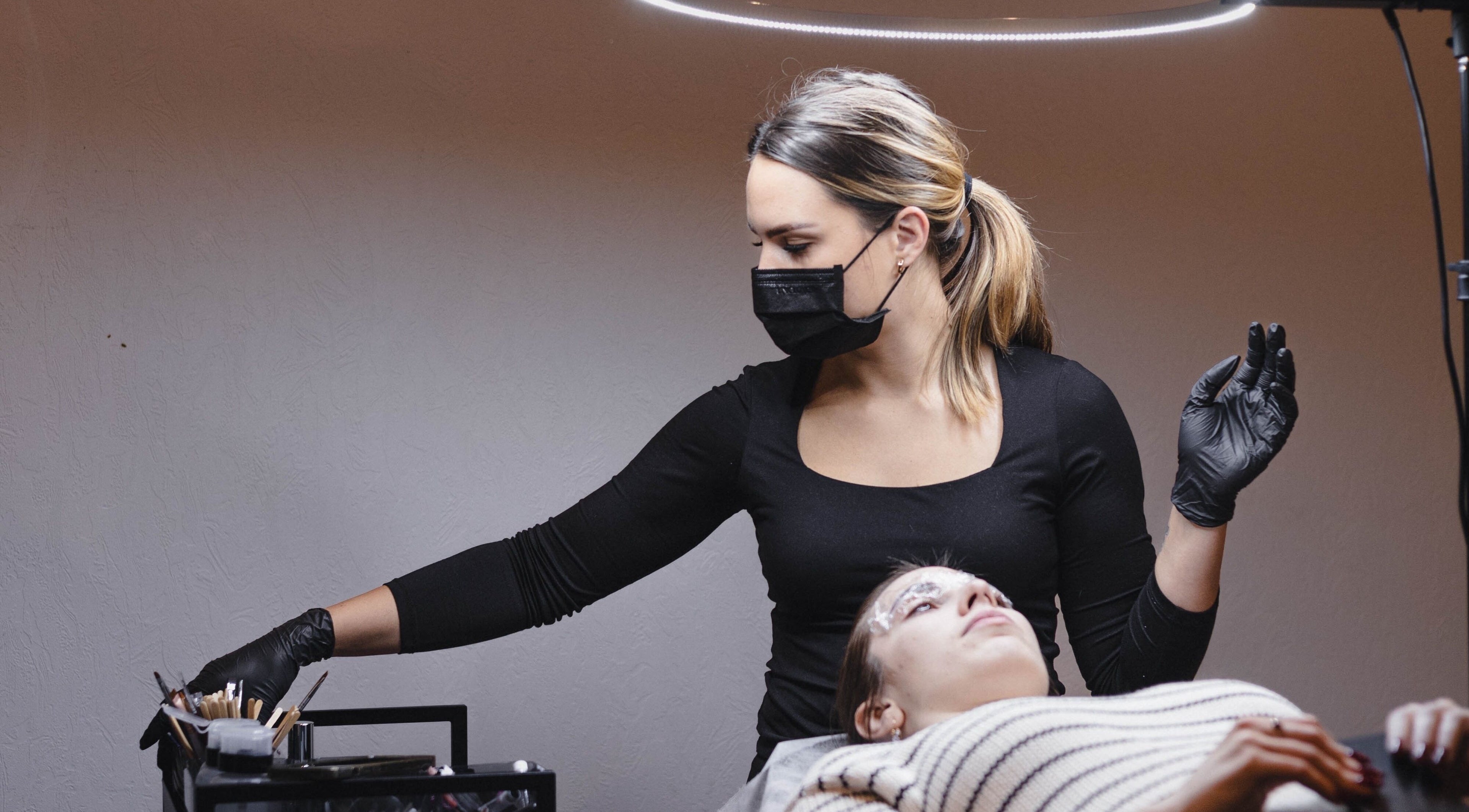 Esthetician performing beauty treatment at Daniella.Esthetics, Rīga, LV. Relaxing ambiance and professional care.