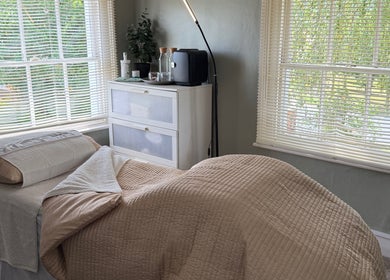 Cozy treatment room at Root and Remedy Wellness in Purleigh, England, GB with soft linens and natural light.