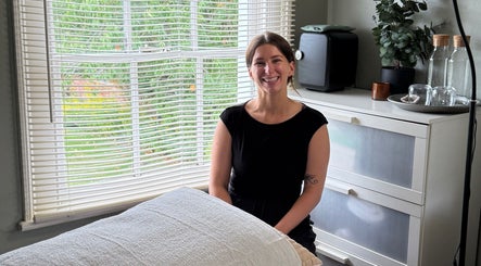 Calm and inviting therapy room at Root and Remedy Wellness in Purleigh, England, GB, showcasing a smiling therapist.