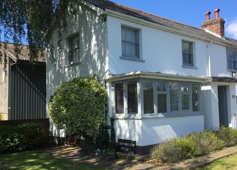 Exterior of Root and Remedy Wellness, a serene white building in Purleigh, England, GB for relaxation and healing.