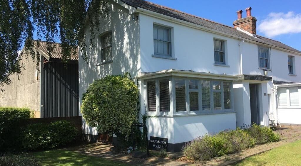 Exterior of Root and Remedy Wellness, a serene white building in Purleigh, England, GB for relaxation and healing.