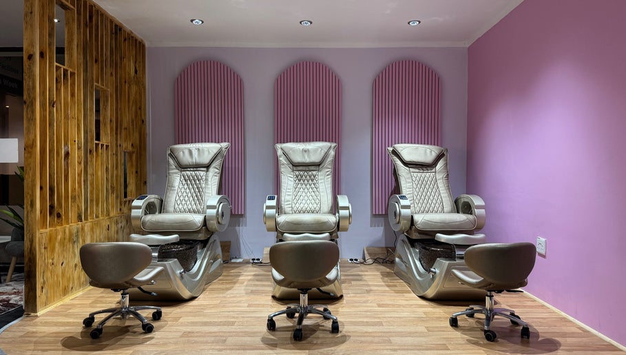 Three luxurious pedicure chairs at Blush and Buff, Cape Town, Western Cape, ZA, with elegant pink accents.