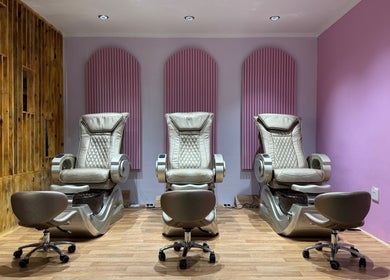 Three luxurious pedicure chairs at Blush and Buff, Cape Town, Western Cape, ZA, with elegant pink accents.
