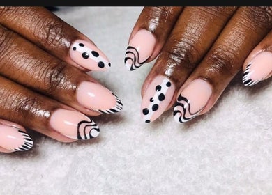 Stylish black and white nail art at Blush and Buff, Cape Town, Western Cape, ZA on a soft towel.