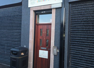 Entrance of Kalos & Grace, Ballymoney, Northern Ireland, GB showcasing a modern door and signage.
