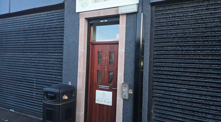 Entrance of Kalos & Grace, Ballymoney, Northern Ireland, GB showcasing a modern door and signage.