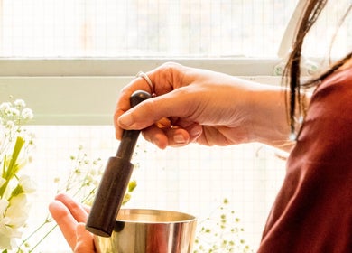 Hands using a mortar at Balance and Bloom Ayurveda at The Float Spa, Brighton And Hove, England, GB.