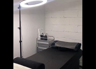 Tranquil treatment room at EyeluxxBeauty, Nassau, New Providence, BS with spa bed and modern lighting.