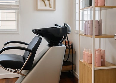 Modern hair wash station at Hair with Gretta, Caloundra, Queensland, AU, complete with product display.