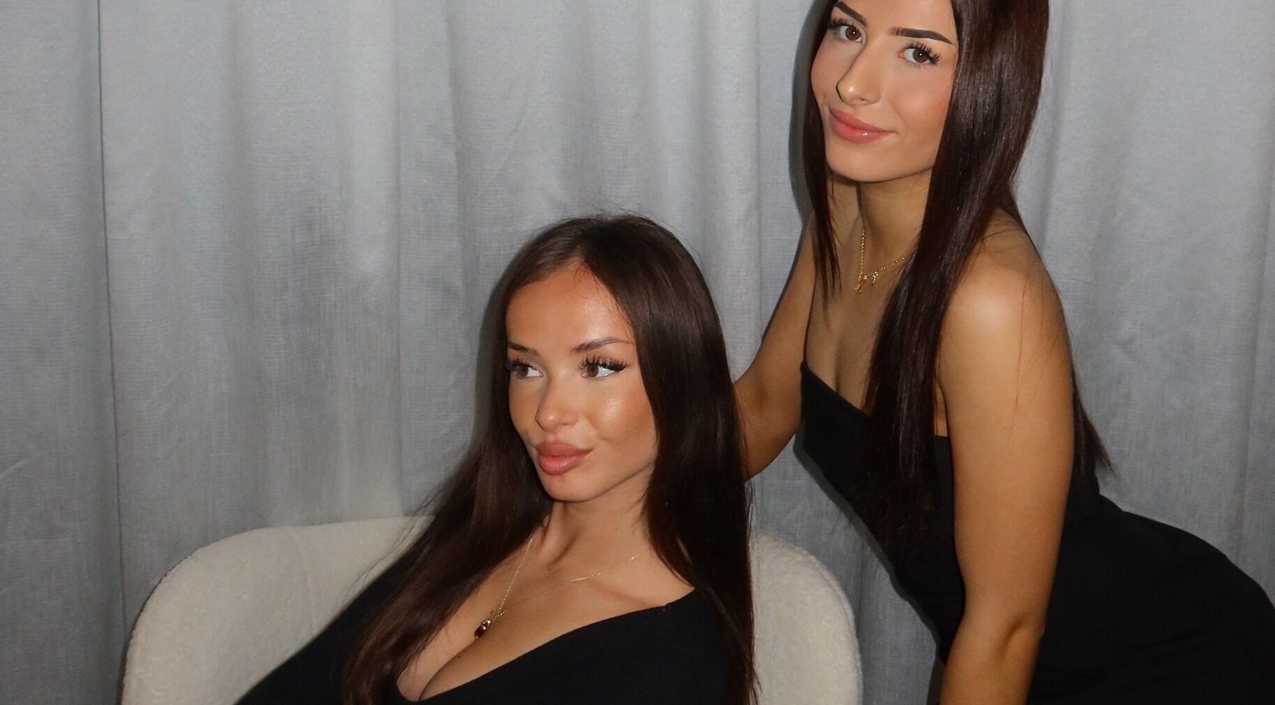 Two women in elegant black outfits posing at Modify Beauty Bar, Melbourne, Victoria, AU.