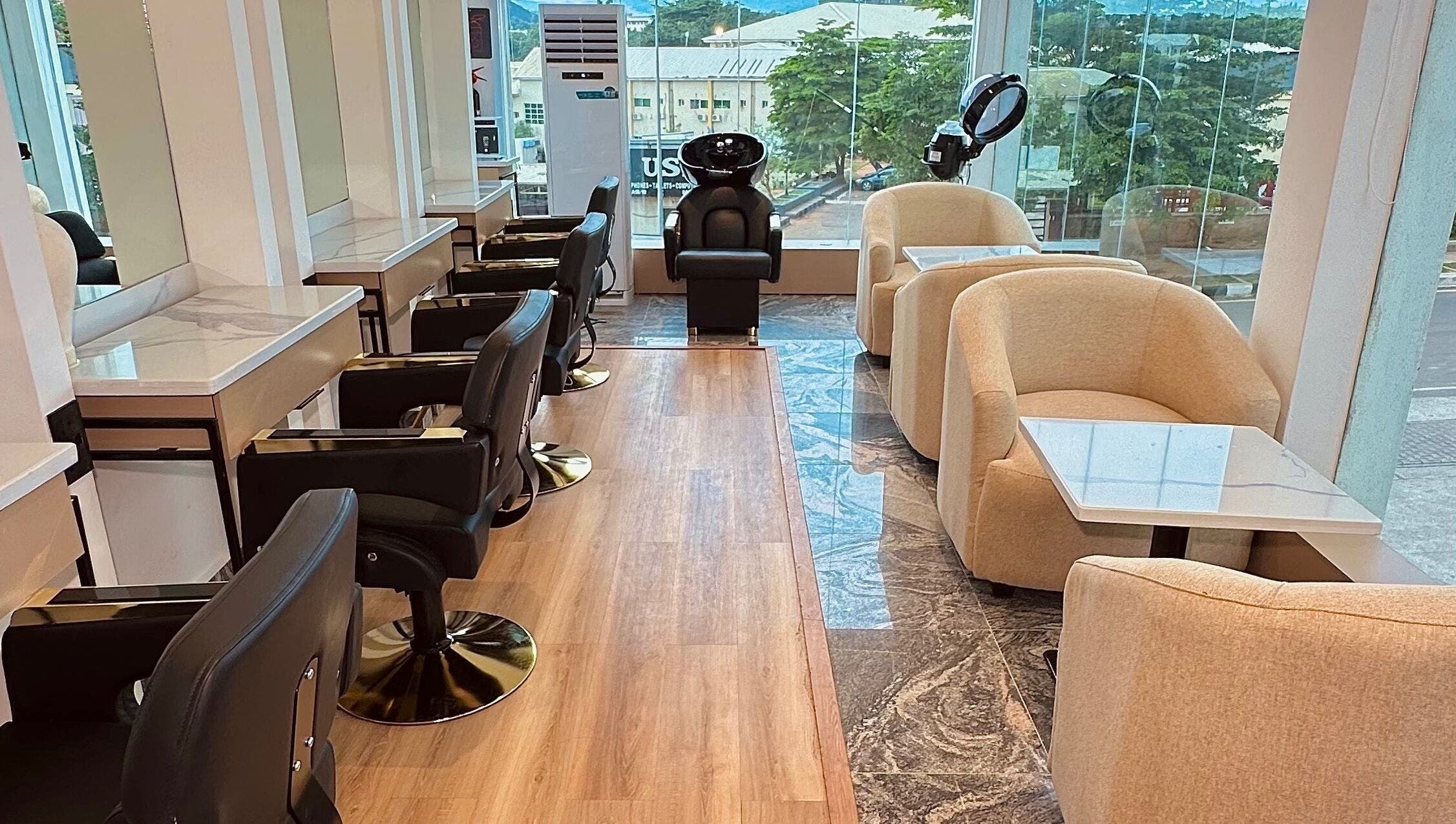 Elegant interior of Elevoire Beauty Lounge in Abuja, featuring modern salon chairs and natural light.