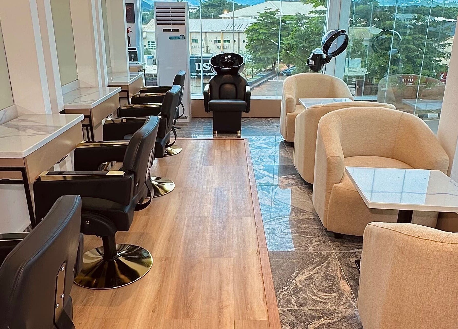 Elegant interior of Elevoire Beauty Lounge in Abuja, featuring modern salon chairs and natural light.