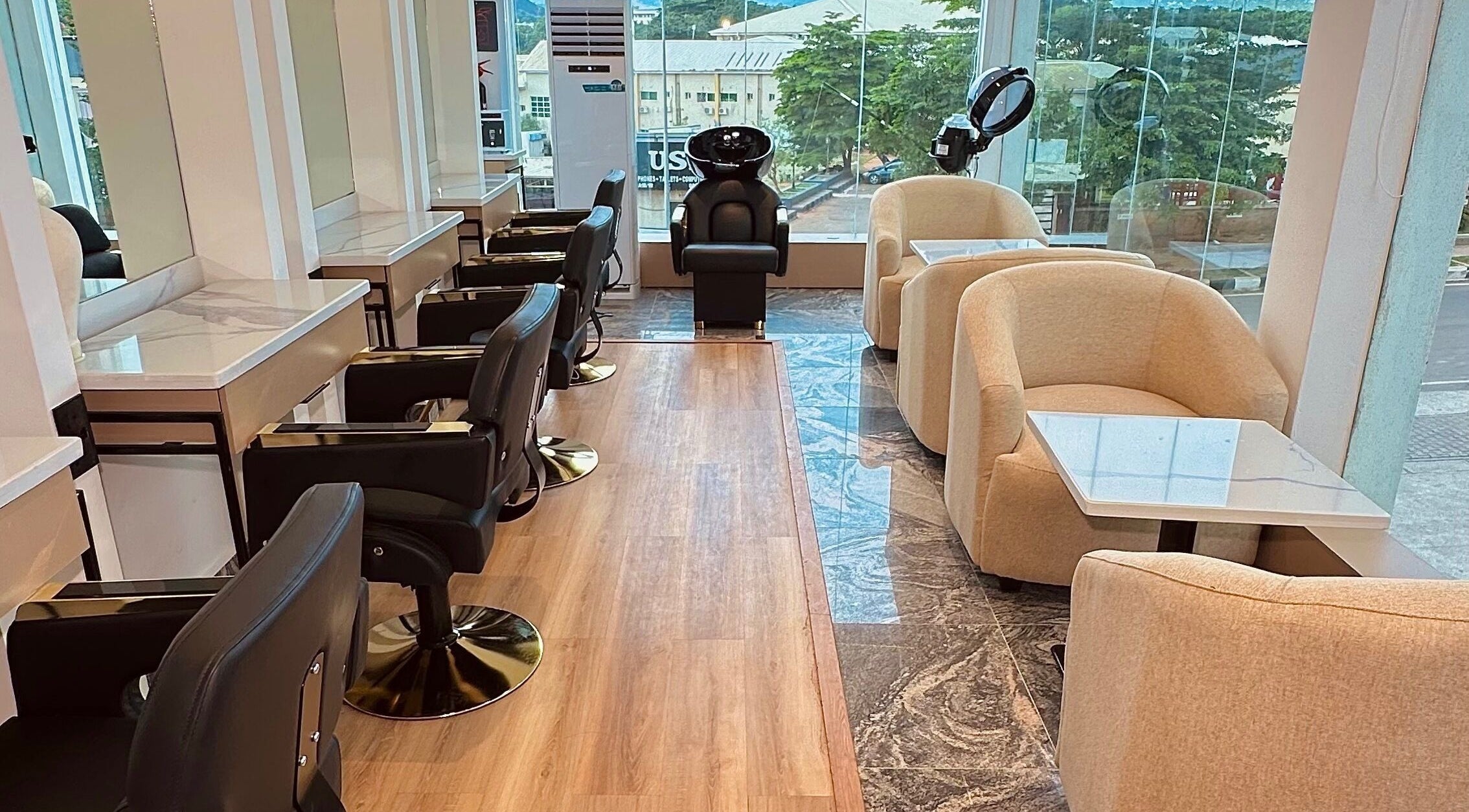 Elegant interior of Elevoire Beauty Lounge in Abuja, featuring modern salon chairs and natural light.
