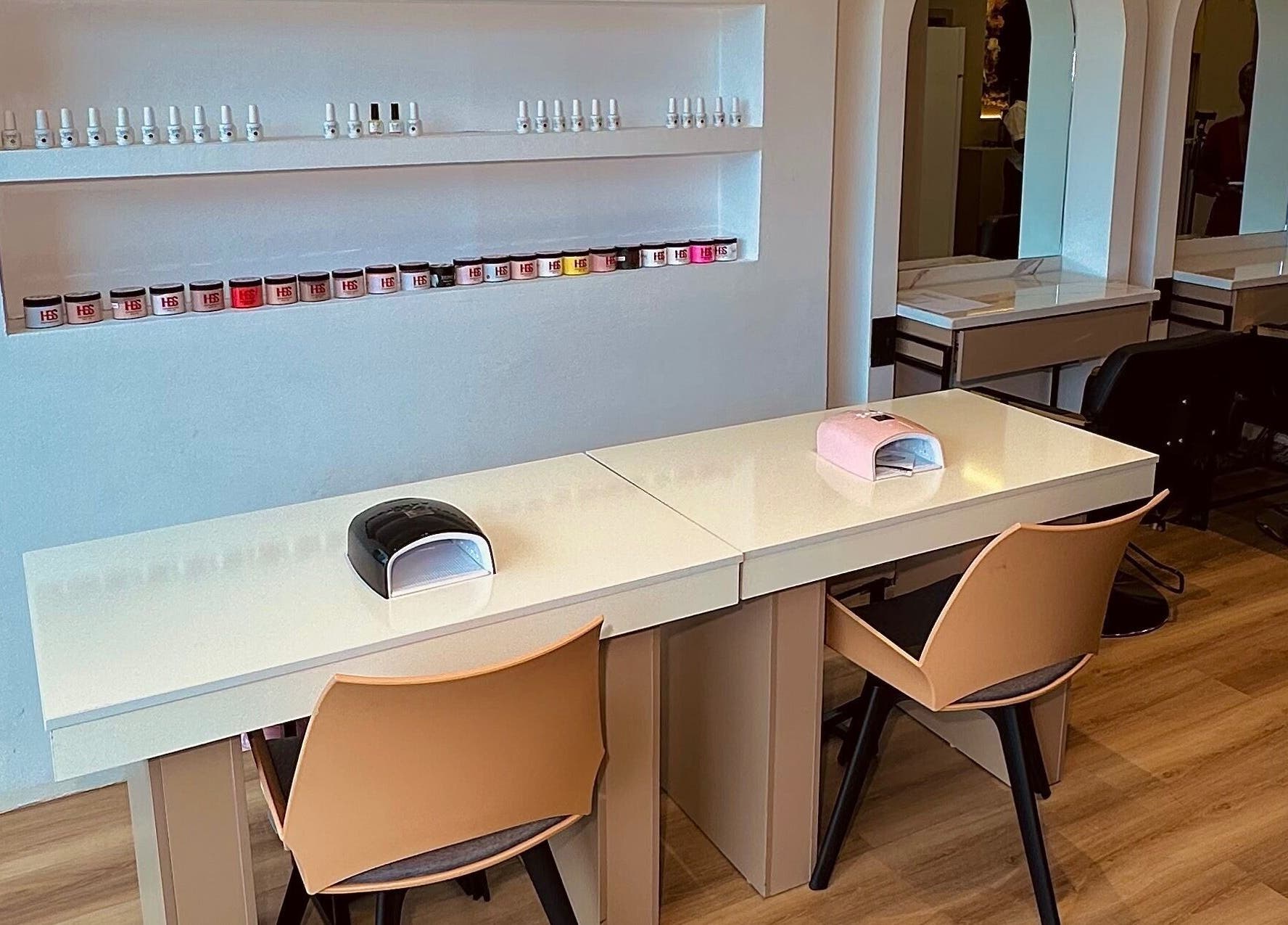 Nail workspace at Elevoire Beauty Lounge, Abuja, Federal Capital Territory, NG with stylish chairs and polish display.
