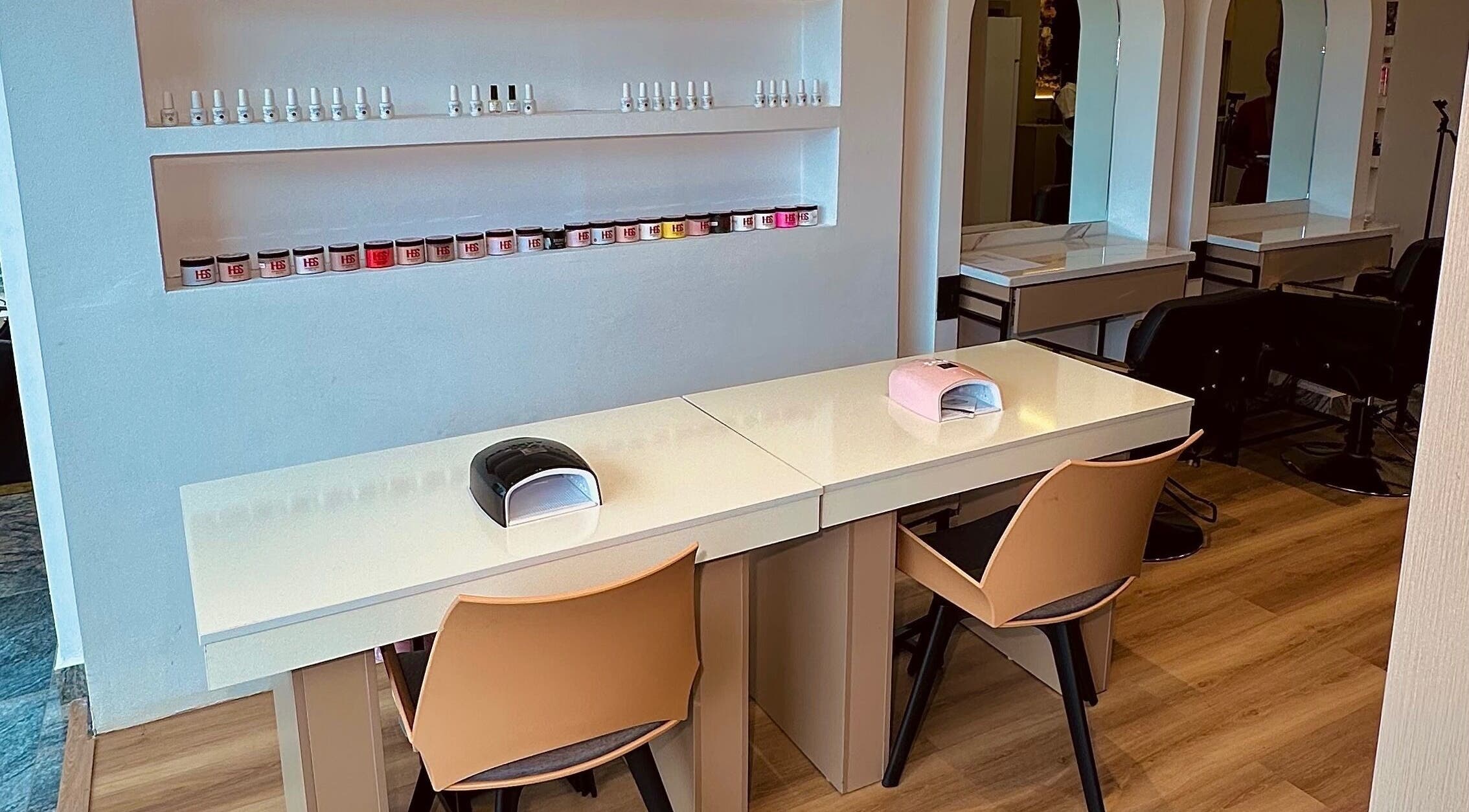 Nail workspace at Elevoire Beauty Lounge, Abuja, Federal Capital Territory, NG with stylish chairs and polish display.