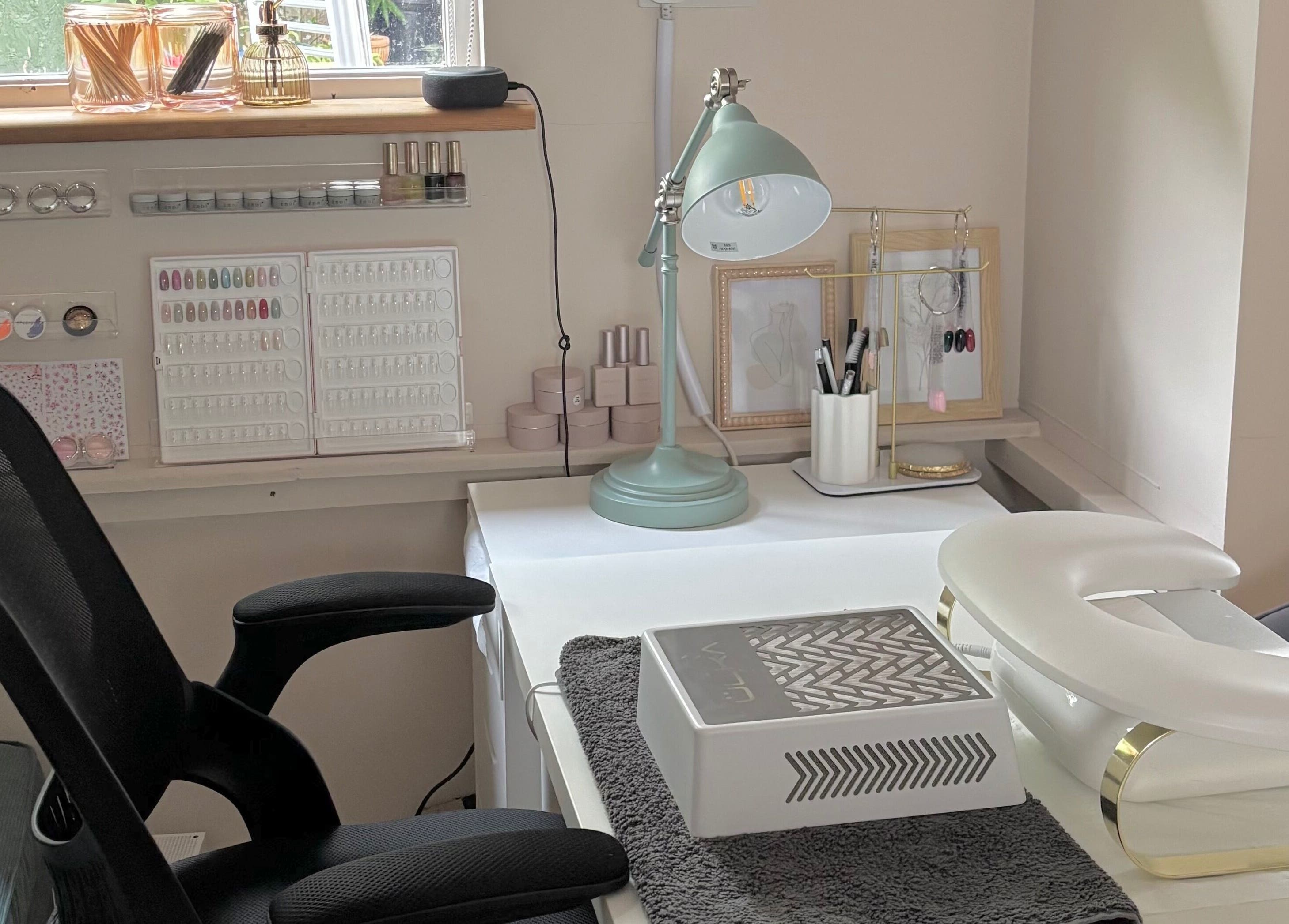 Elegant nail salon station at Bebe Nails, New Malden, England, GB, featuring manicure tools and modern decor.