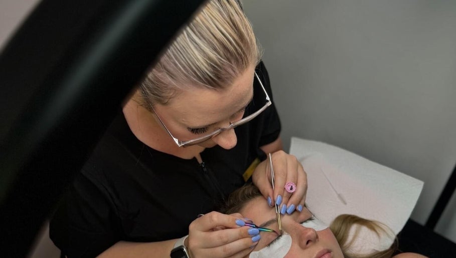 Lash artist applying extensions at Lashes by Lucia, Cape Town, Western Cape, ZA.