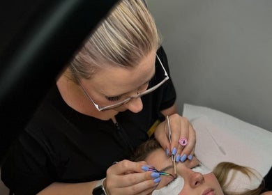 Lash artist applying extensions at Lashes by Lucia, Cape Town, Western Cape, ZA.