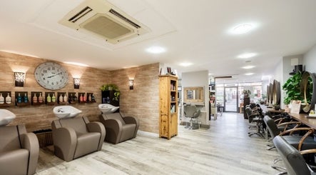 Chic interiors of The Nik Effect salon in Birmingham, England, GB showcasing modern styling stations.
