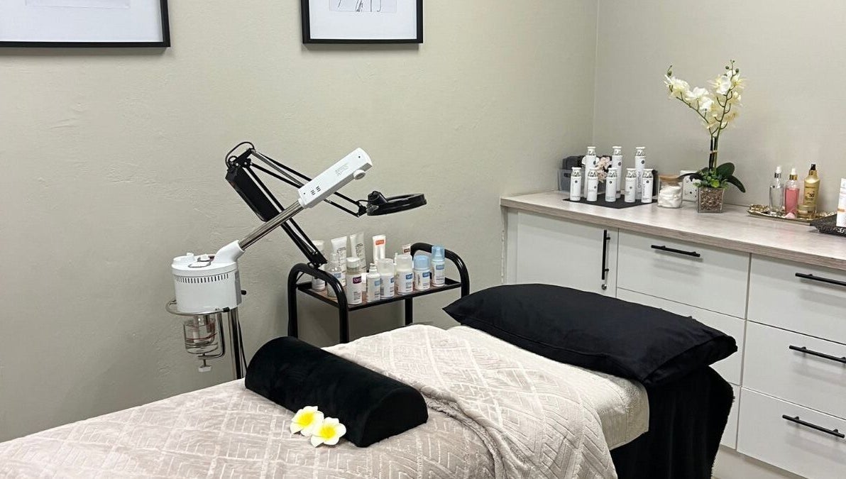 Serene treatment room at Ayla Glow Bar, Boksburg, Gauteng, ZA, showcasing luxury skincare products and a cozy bed.