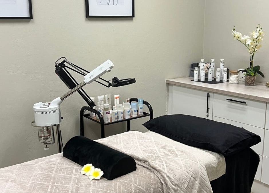 Serene treatment room at Ayla Glow Bar, Boksburg, Gauteng, ZA, showcasing luxury skincare products and a cozy bed.