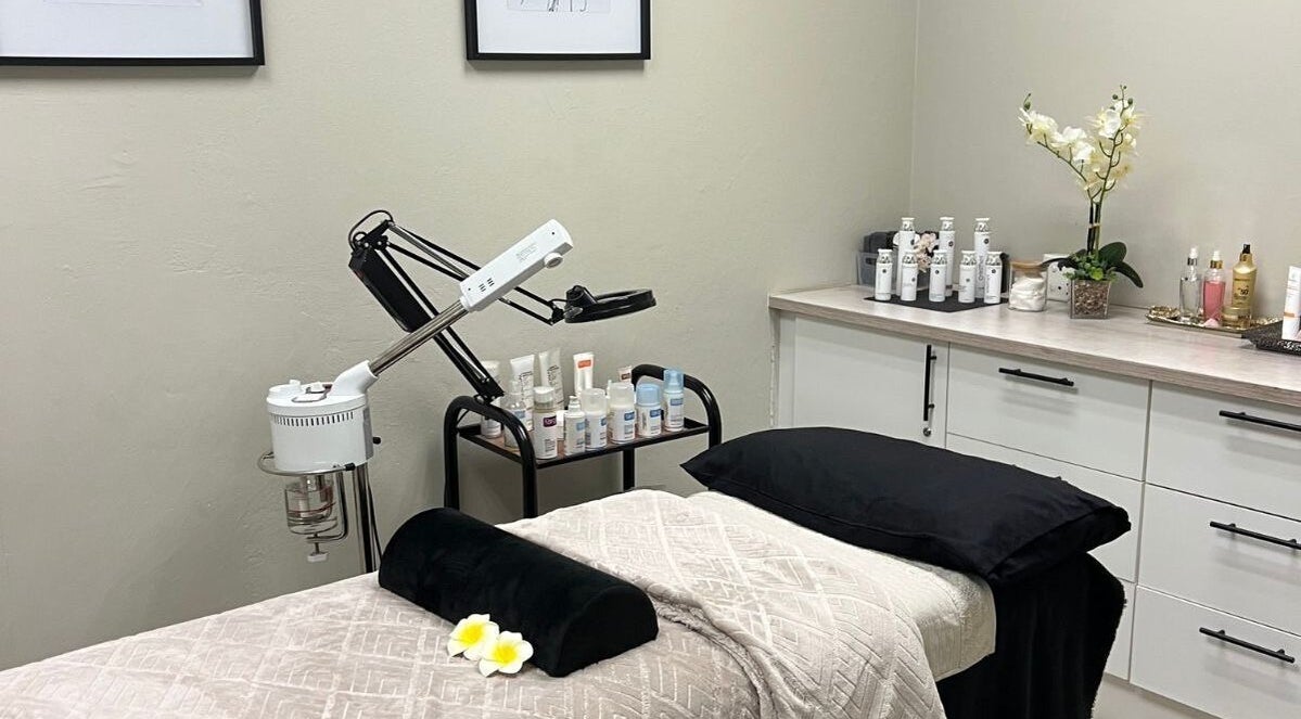 Serene treatment room at Ayla Glow Bar, Boksburg, Gauteng, ZA, showcasing luxury skincare products and a cozy bed.