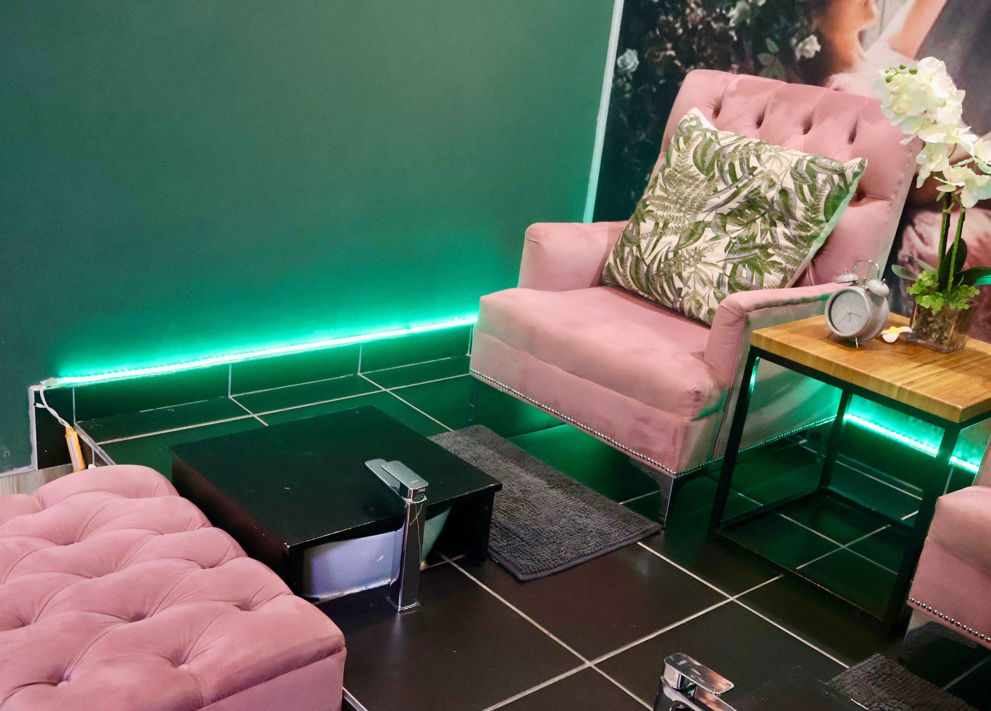 Elegant seating area at Ayla Glow Bar, Boksburg, Gauteng, ZA with pink chairs and a green backdrop.