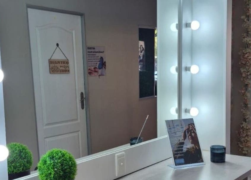 Elegant vanity area at Ayla Glow Bar, Boksburg, Gauteng, ZA featuring a lit mirror and decor.