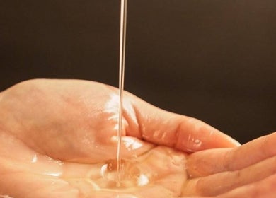 Minyak pijat mengalir di tangan di Massage Oil Home Spa, Kalimantan Tengah, Kalimantan Tengah, ID.