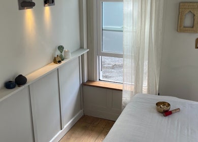 Tranquil massage room at FOLK, Perranporth, England, GB with soft lighting and peaceful decor.