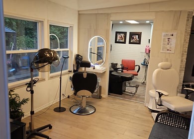 Modern salon interior at Jane hairstylist in Hamilton, Ontario, CA, featuring stylish seating and large mirrors.
