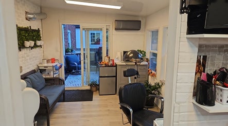 Cozy salon interior at Jane hairstylist in Hamilton, Ontario, CA showcasing modern decor and styling chair.