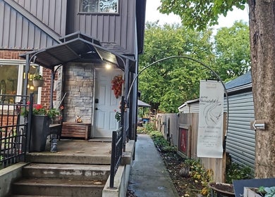 Welcoming front view of Jane hairstylist in Hamilton, Ontario, CA with garden and stone décor.
