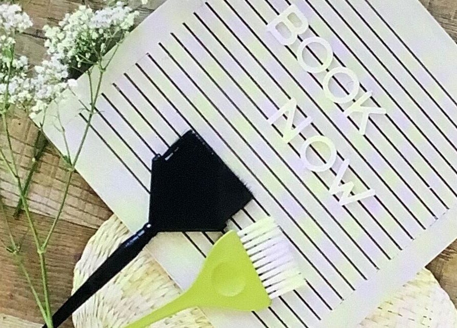 Booking sign with hairstyling tools at Hair by Greshan, Edgecliff, New South Wales, AU.