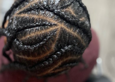 Intricate braided hairstyle at Chineeys Hairempire, San Fernando City Corporation, TT.
