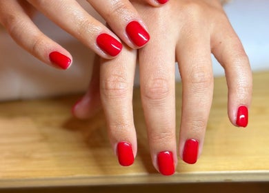 Bright red manicure at Mano Mona Nails, Bondi Beach, New South Wales, AU showcasing elegant nail design.