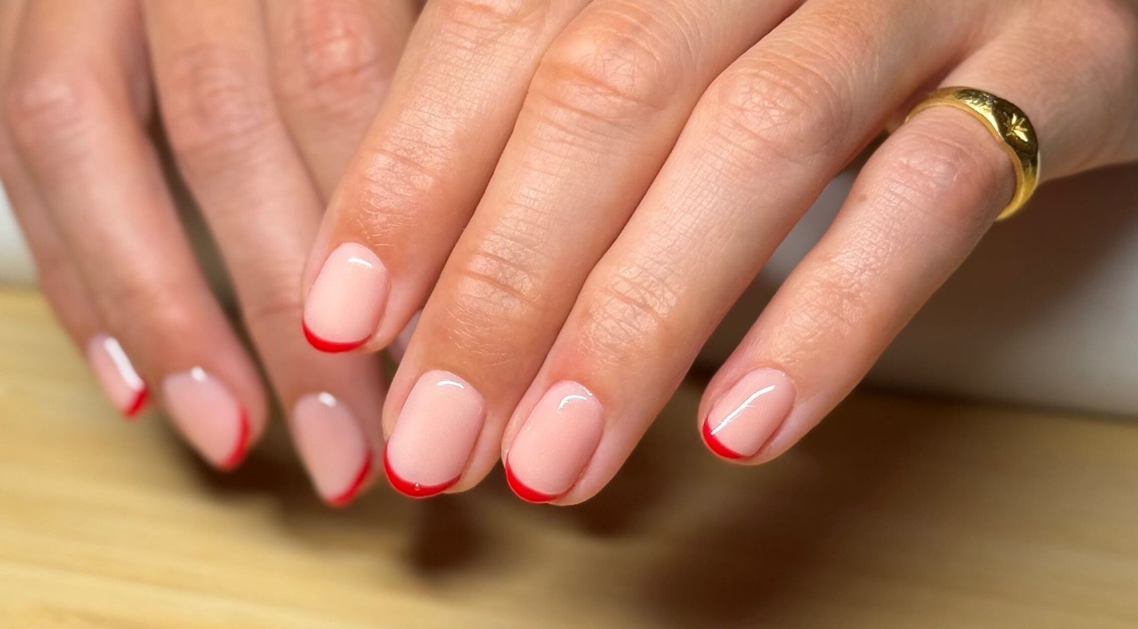 Elegant red-tipped nails at Mano Mona Nails, Bondi Beach, New South Wales, AU offering stunning manicures.
