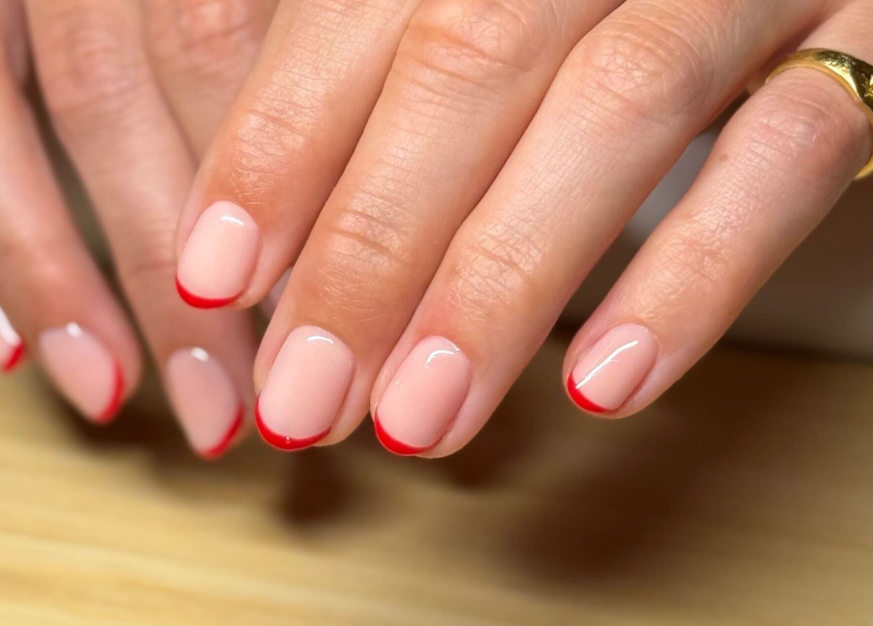 Elegant red-tipped nails at Mano Mona Nails, Bondi Beach, New South Wales, AU, showcasing nail art expertise.