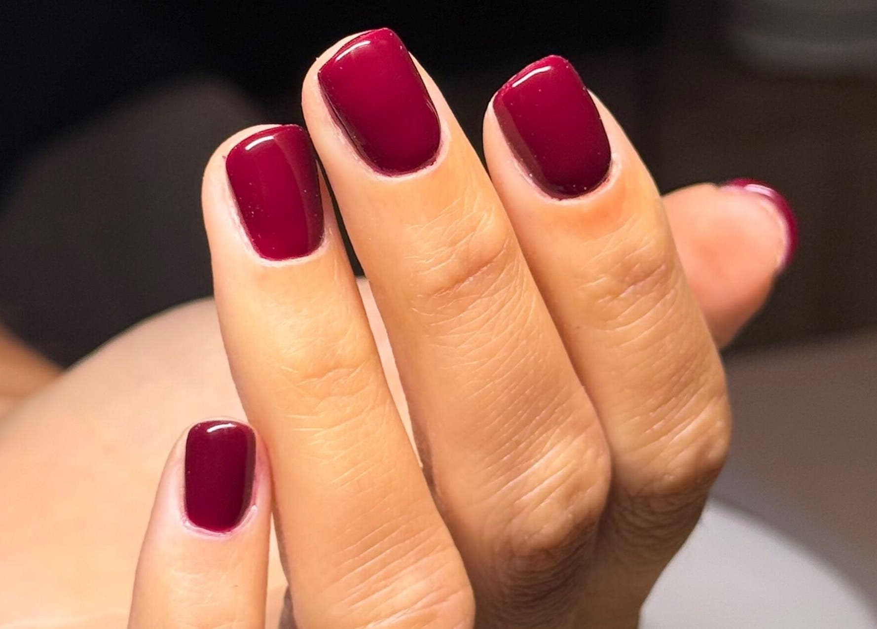 Close-up of elegant ruby red nails at Mano Mona Nails, Bondi Beach, New South Wales, AU.