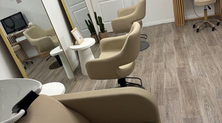 Modern beige salon chair setup at Desert Chic Hair, Urangan, Queensland, AU.