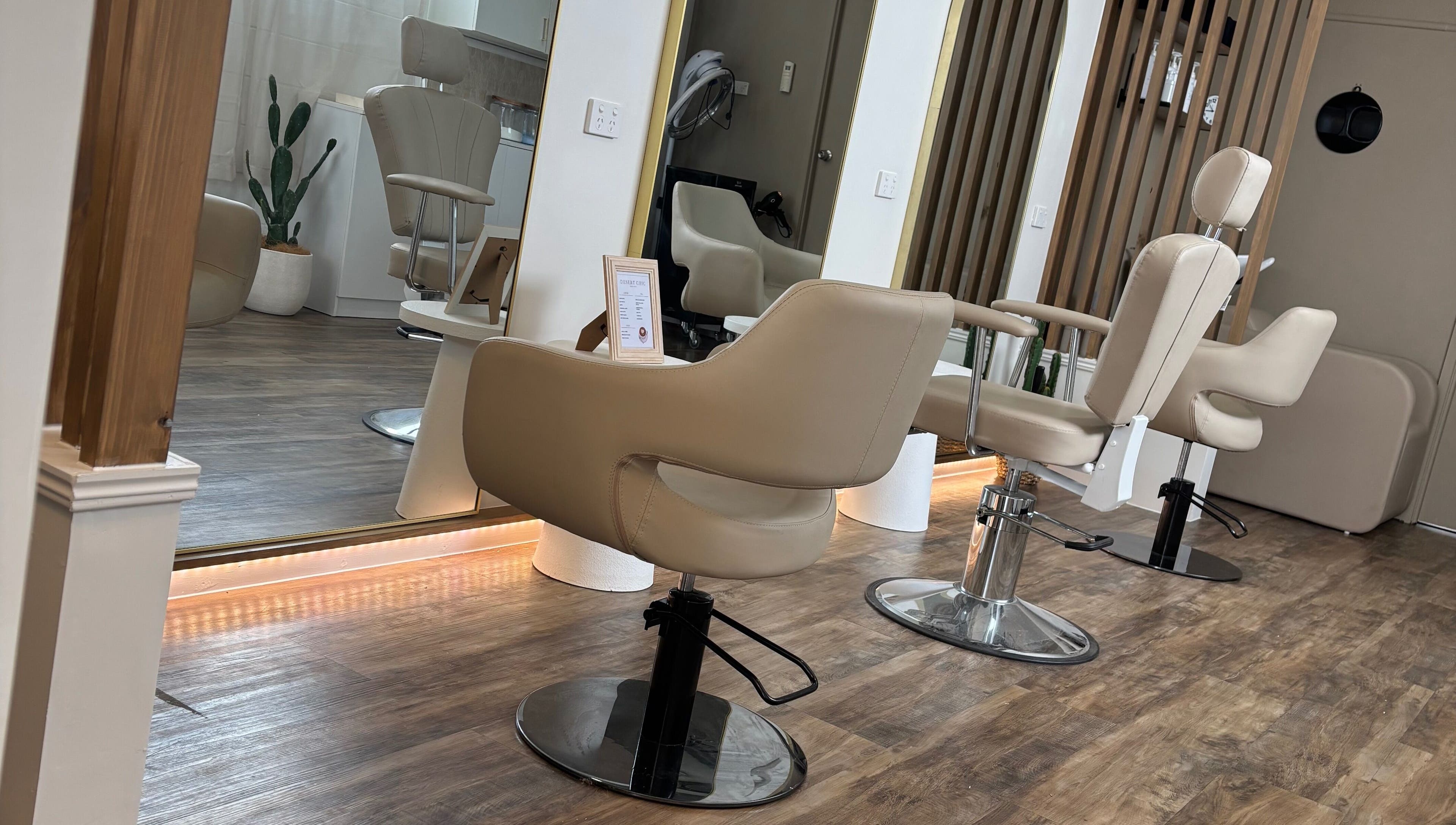 Chic salon chairs at Desert Chic Hair, Pialba, Queensland, AU, offering a stylish and relaxing setting.