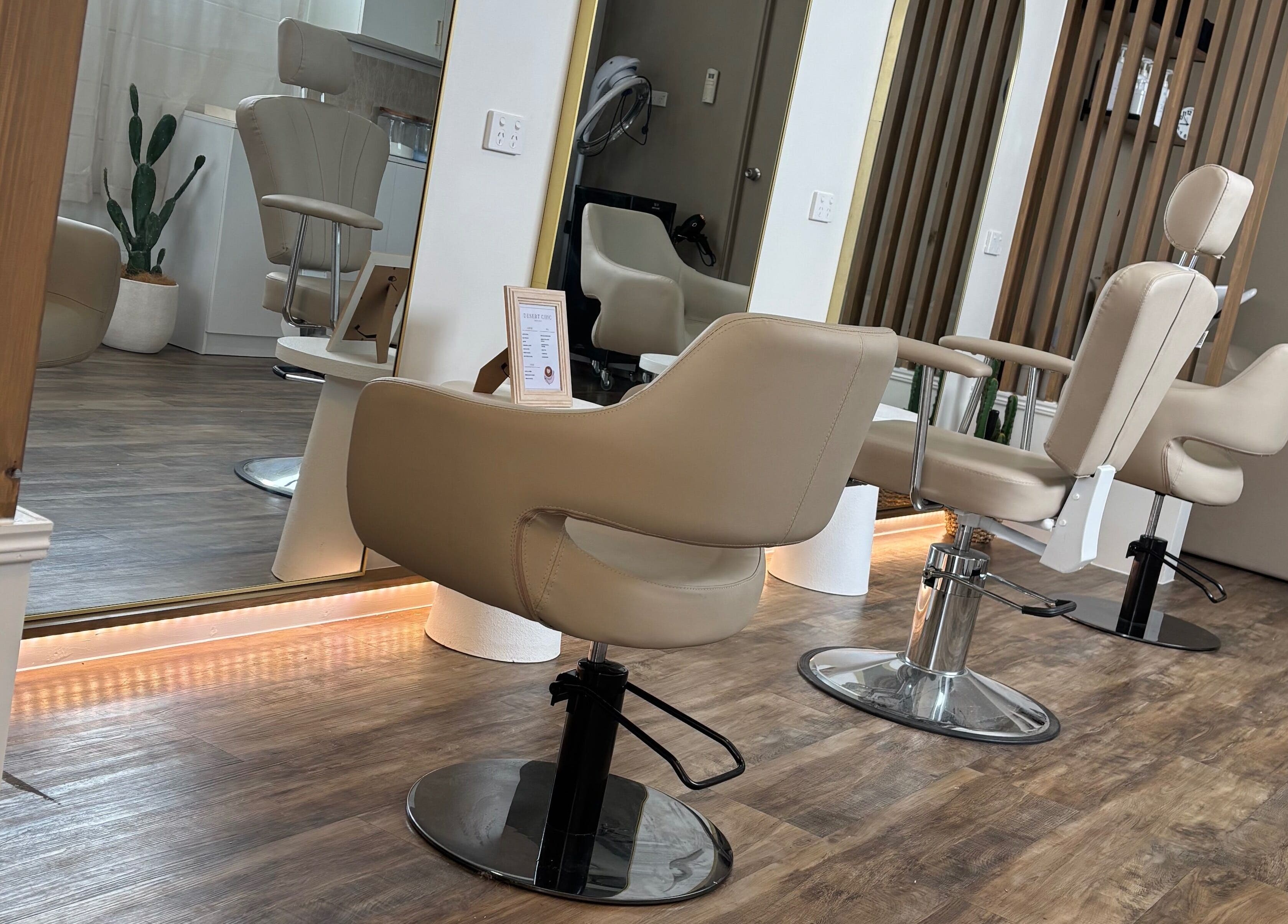 Chic salon chairs at Desert Chic Hair, Pialba, Queensland, AU, offering a stylish and relaxing setting.