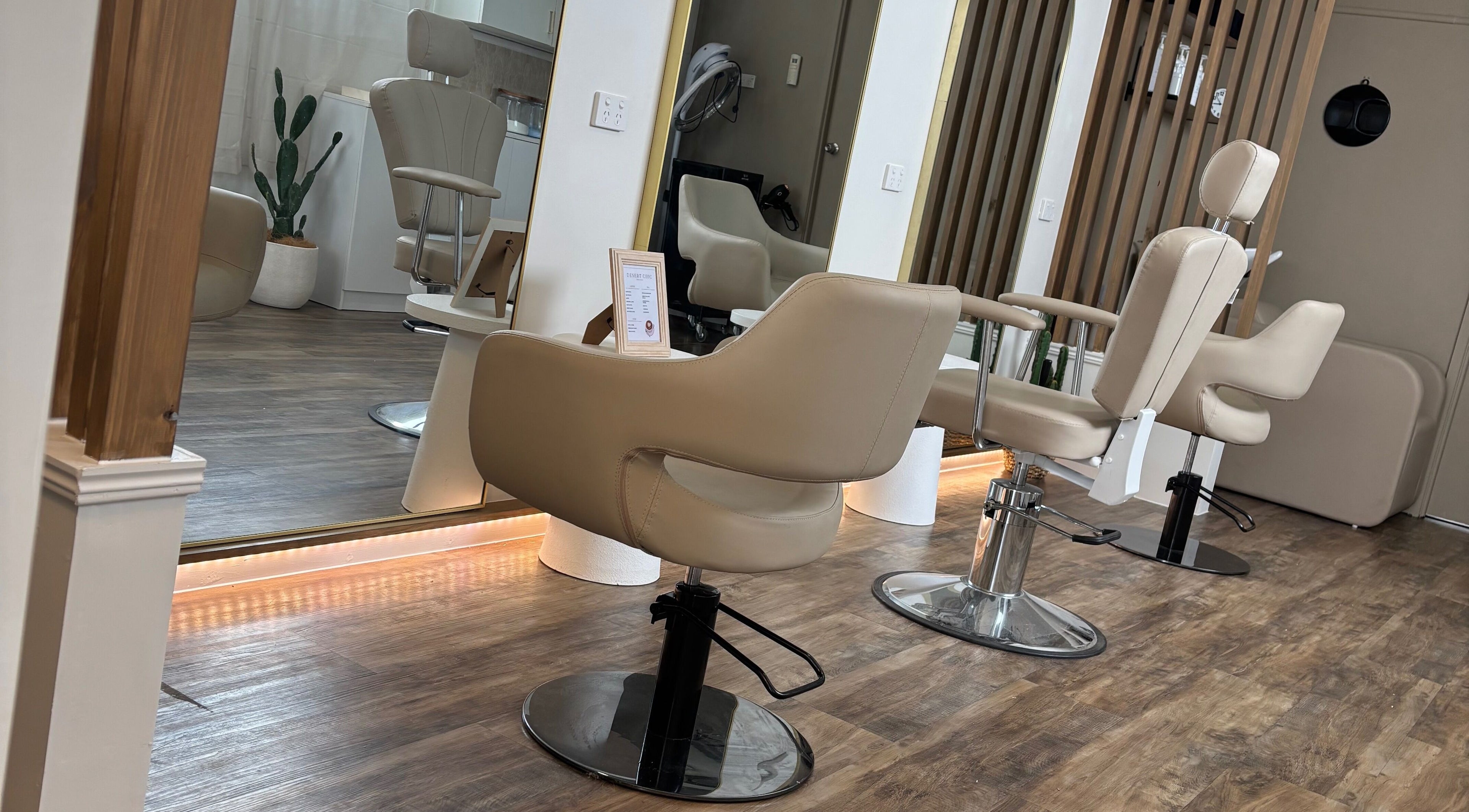 Chic salon chairs at Desert Chic Hair, Pialba, Queensland, AU, offering a stylish and relaxing setting.