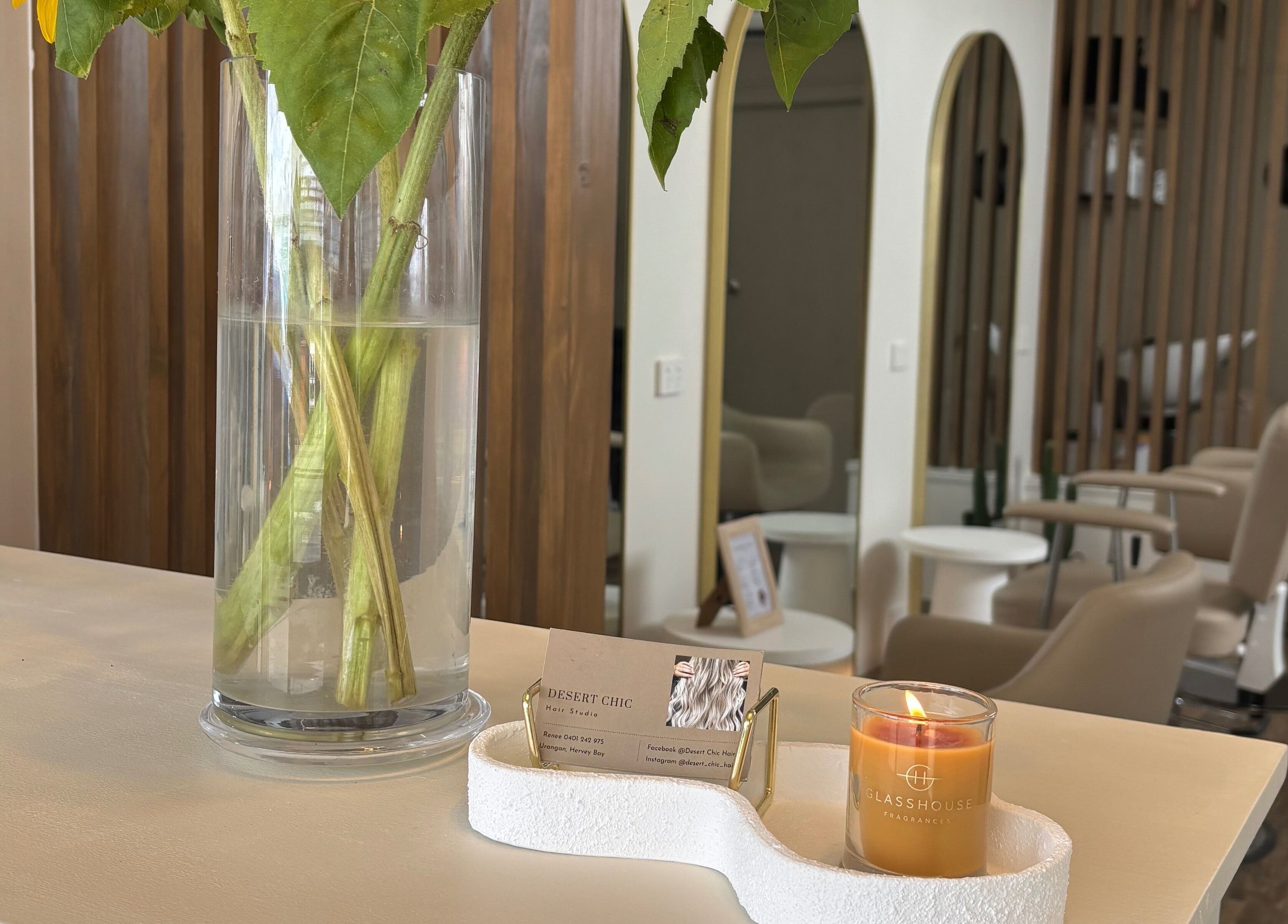 Welcoming interior of Desert Chic Hair in Pialba, Queensland, AU, adorned with fresh flowers and cozy decor.