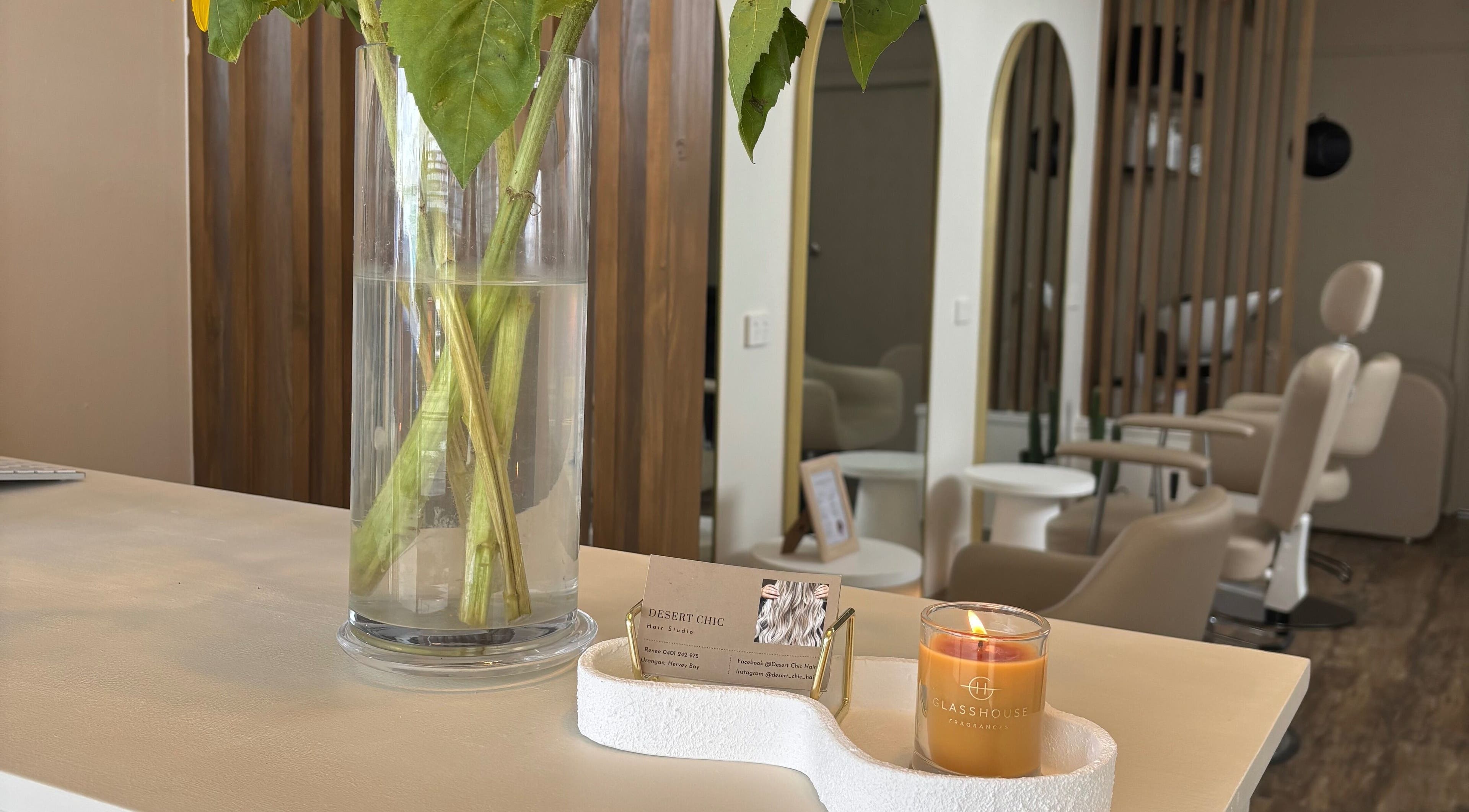 Welcoming interior of Desert Chic Hair in Pialba, Queensland, AU, adorned with fresh flowers and cozy decor.