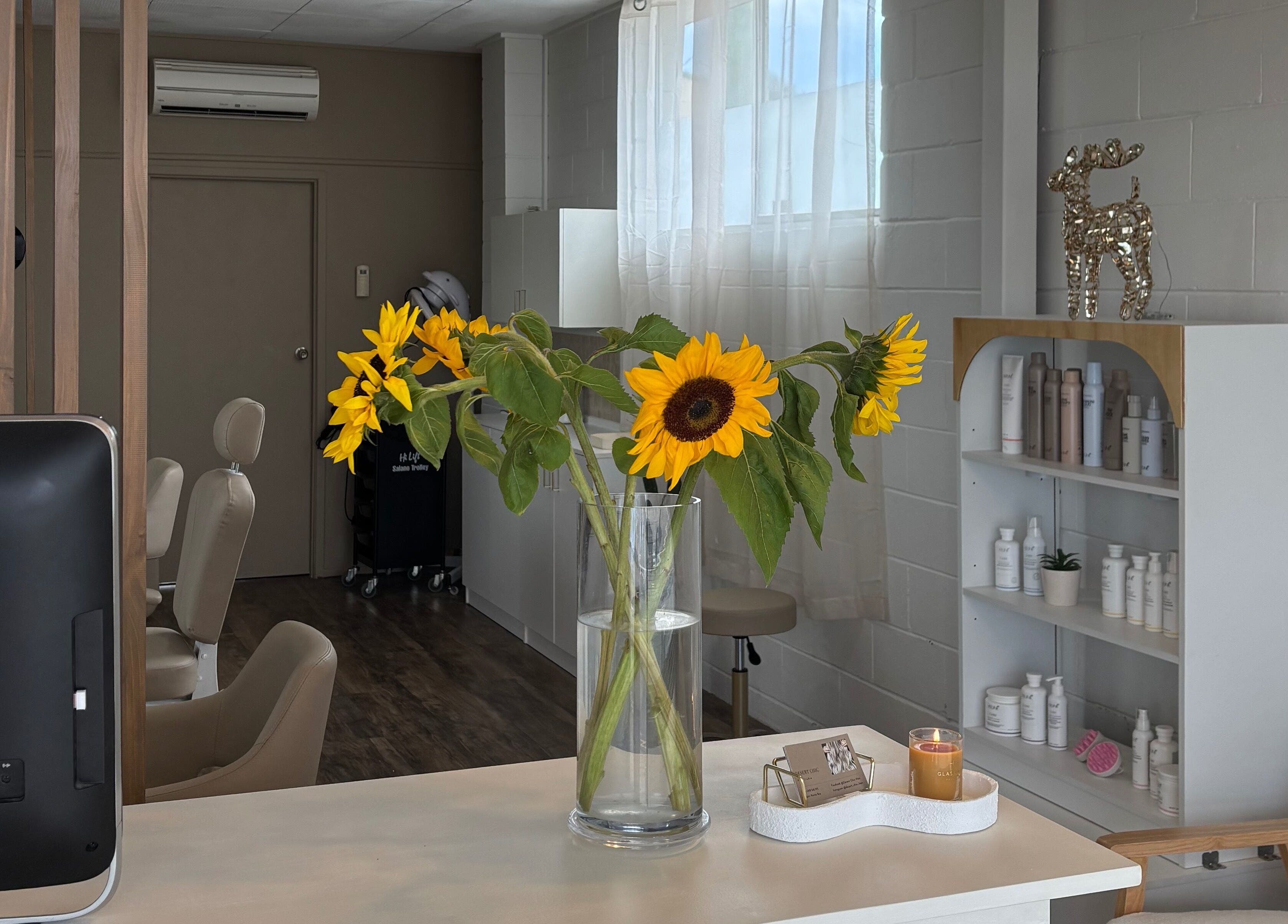Bright sunflowers at Desert Chic Hair in Pialba, Queensland, create a welcoming atmosphere.