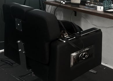 Sleek black barber chair at Barber On Wheels, Gqeberha, Eastern Cape, ZA, ready for a stylish haircut.